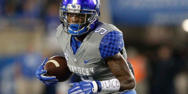 Sep 26, 2015; Lexington, KY, USA; Kentucky Wildcats wide receiver Garrett Johnson (9) runs the ball against the Missouri Tigers in the first half at Commonwealth Stadium. Mandatory Credit: Mark Zerof-USA TODAY Sports