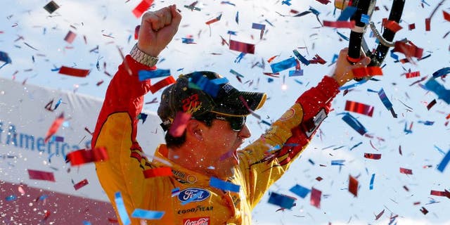 CHARLOTTE, NC - OCTOBER 11: Joey Logano, driver of the #22 Shell Pennzoil Ford, celebrates in Victory Lane after winning the NASCAR Sprint Cup Series Bank of America 500 at Charlotte Motor Speedway on October 11, 2015 in Charlotte, North Carolina. (Photo by Jonathan Ferrey/Getty Images)