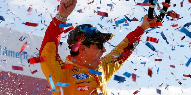 CHARLOTTE, NC - OCTOBER 11: Joey Logano, driver of the #22 Shell Pennzoil Ford, celebrates in Victory Lane after winning the NASCAR Sprint Cup Series Bank of America 500 at Charlotte Motor Speedway on October 11, 2015 in Charlotte, North Carolina. (Photo by Jonathan Ferrey/Getty Images)