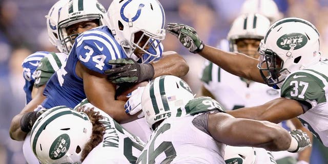 INDIANAPOLIS, IN - SEPTEMBER 21: Josh Robinson #34 of the Indianapolis Colts is tackled by the New York Jets defense during the game at Lucas Oil Stadium on September 21, 2015 in Indianapolis, Indiana. (Photo by Andy Lyons/Getty Images)