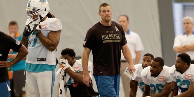 Miami Dolphins interim coach Dan Campbell walks on the field during NFL football practice in Davie, Fla., Wednesday, Oct. 7, 2015. (AP Photo/Alan Diaz)