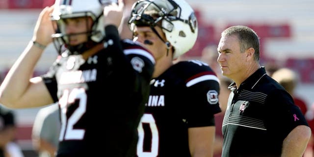 COLUMBIA, SC - OCTOBER 17: Interim head coach Shawn Elliott of the South Carolina Gamecocks watches on as quarterbacks Michael Scarnecchia #12 and Perry Orth #10 of the South Carolina Gamecocks warm up before their game against the Vanderbilt Commodores at Williams-Brice Stadium on October 17, 2015 in Columbia, South Carolina. (Photo by Streeter Lecka/Getty Images)