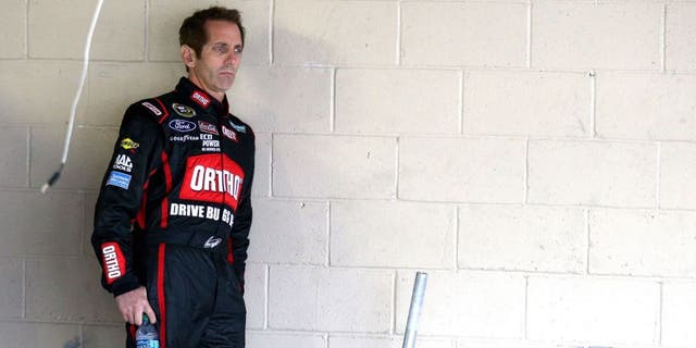 DOVER, DE - OCTOBER 03: Greg Biffle, driver of the #16 Ortho Ford, looks on in the garage area during practice for the NASCAR Sprint Cup Series AAA 400 at Dover International Speedway on October 3, 2015 in Dover, Delaware. (Photo by Patrick Smith/Getty Images)