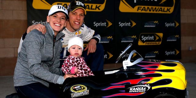 KANSAS CITY, KS - OCTOBER 16: Brad Keselowski, driver of the #2 Miller Lite Ford, poses with his girlfriend Paige White and their daughter Scarlett after Keselowski qualified on the pole for the NASCAR Sprint Cup Series Hollywood Casino 400 at Kansas Speedway on October 16, 2015 in Kansas City, Kansas. (Photo by Brian Lawdermilk/NASCAR via Getty Images)