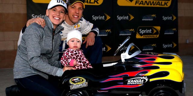 KANSAS CITY, KS - OCTOBER 16: Brad Keselowski, driver of the #2 Miller Lite Ford, poses with his girlfriend Paige White and their daughter Scarlett after Keselowski qualified on the pole for the NASCAR Sprint Cup Series Hollywood Casino 400 at Kansas Speedway on October 16, 2015 in Kansas City, Kansas. (Photo by Brian Lawdermilk/NASCAR via Getty Images)