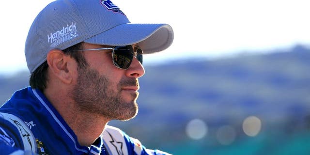 KANSAS CITY, KS - OCTOBER 16: Jimmie Johnson, driver of the #48 Lowe's Chevrolet, looks on during qualifying for the NASCAR Sprint Cup Series Hollywood Casino 400 at Kansas Speedway on October 16, 2015 in Kansas City, Kansas. (Photo by Daniel Shirey/Getty Images)