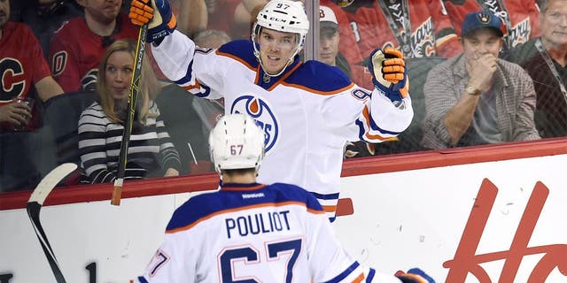 Oct 17, 2015; Calgary, Alberta, CAN; Edmonton Oilers center Connor McDavid (97) celebrates his second period goal against the Calgary Flames at Scotiabank Saddledome. Mandatory Credit: Candice Ward-USA TODAY Sports