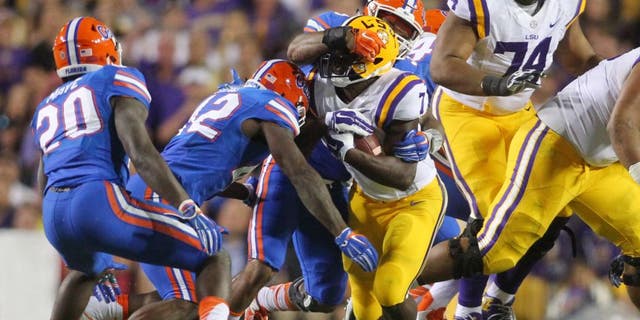 Oct 17, 2015; Baton Rouge, LA, USA; LSU Tigers running back Leonard Fournette (7) is tackled by Florida Gators linebacker Antonio Morrison (3) at Tiger Stadium. Mandatory Credit: Crystal LoGiudice-USA TODAY Sports