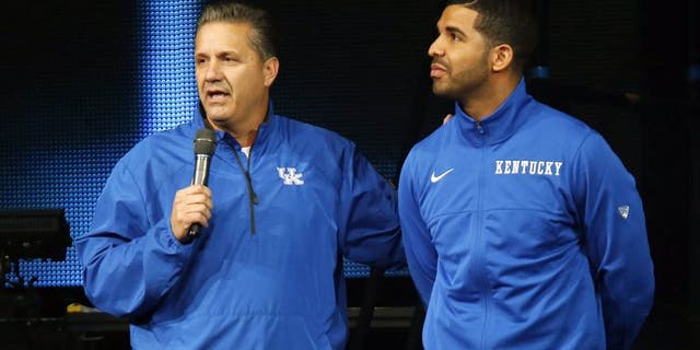 CORRECTS DAY OF WEEK TO FRIDAY - Kentucky coach John Calipari, left, and hip-hop star Drake speak during the team's NCAA college basketball Big Blue Madness, Friday, Oct. 17, 2014, in Lexington, Ky. (AP Photo/James Crisp)