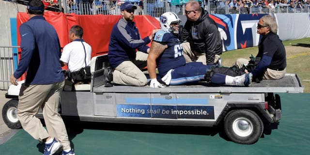 Tennessee Titans center Brian Schwenke (62) is taken off the field after injuring his leg in the first half of an NFL football game against the Miami Dolphins Sunday, Oct. 18, 2015, in Nashville, Tenn. (AP Photo/James Kenney)