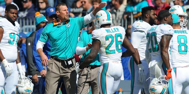 Oct 18, 2015; Nashville, TN, USA; Miami Dolphins interim head coach Dan Campbell (C) celebrates with players after a touchdown during the first half against the Tennessee Titans at Nissan Stadium. Mandatory Credit: Christopher Hanewinckel-USA TODAY Sports