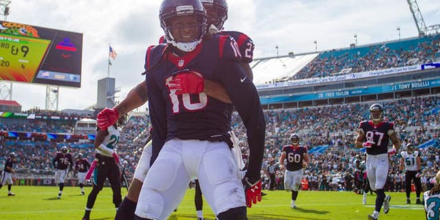 Oct 18, 2015; Jacksonville, FL, USA; Houston Texans running back Arian Foster (behind) celebrates with Houston Texans wide receiver DeAndre Hopkins (10) after a touchdown against the Jacksonville Jaguars at EverBank Field. The Houston Texans won 31-20. Mandatory Credit: Logan Bowles-USA TODAY Sports