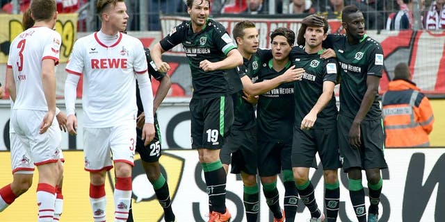 Hannoverôs players celebrate during the German first division Bundesliga football match 1 FC Cologne vs Hanover 96 in Cologne, western Germany, on October 18, 2015. AFP PHOTO / PATRIK STOLLARZ RESTRICTIONS: DURING MATCH TIME: DFL RULES TO LIMIT THE ONLINE USAGE TO 15 PICTURES PER MATCH AND FORBIDS IMAGE SEQUENCES TO SIMULATE VIDEO. == RESTRICTED TO EDITORIAL USE == FOR FURTHER QUERIES PLEASE CONTACT DFL DIRECTLY AT + 49 69 650050. (Photo credit should read PATRIK STOLLARZ/AFP/Getty Images)