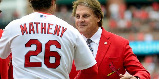 ST. LOUIS, MO - APRIL 13: Former St. Louis Cardinals manager Tony La Russa greets manager Mike Matheny #26 before a game against the Milwaukee Brewers at Busch Stadium on April 13, 2015 in St. Louis, Missouri. (Photo by Jeff Curry/Getty Images)