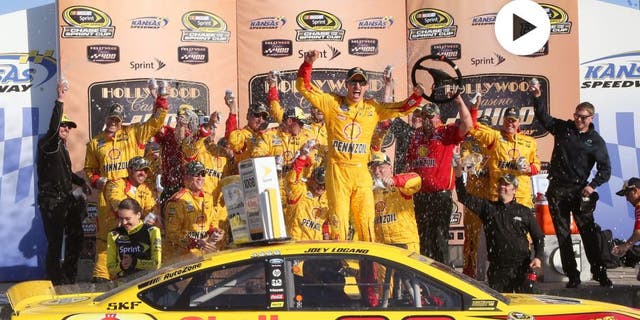 Joey Logano, driver of the #22 Shell Pennzoil Ford, celebrates in Victory Lane after winning the NASCAR Sprint Cup Series Hollywood Casino 400 at Kansas Speedway on October 18, 2015 in Kansas City, Kansas. (Photo by Jerry Markland/Getty Images)