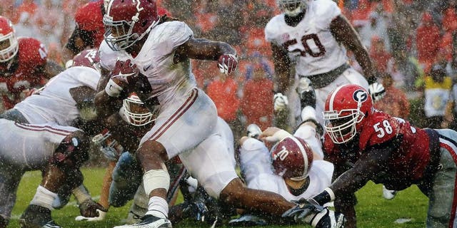ATHENS, GA - OCTOBER 03: Derrick Henry #2 of the Alabama Crimson Tide breaks a tackle by Sterling Bailey #58 of the Georgia Bulldogs at Sanford Stadium on October 3, 2015 in Athens, Georgia. (Photo by Kevin C. Cox/Getty Images)