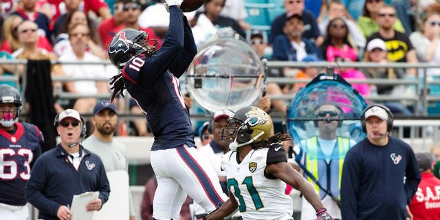 Oct 18, 2015; Jacksonville, FL, USA; Houston Texans wide receiver DeAndre Hopkins (10) makes a catch over Jacksonville Jaguars cornerback Davon House (right) in the second quarter at EverBank Field. Mandatory Credit: Logan Bowles-USA TODAY Sports