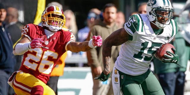 Oct 18, 2015; East Rutherford, NJ, USA; New York Jets wide receiver Brandon Marshall (15) carries the ball past Washington Redskins cornerback Bashaud Breeland (26) in the second half against the Washington Redskins at MetLife Stadium. The Jets won 34-20. Mandatory Credit: Vincent Carchietta-USA TODAY Sports