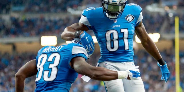 Oct 18, 2015; Detroit, MI, USA; Detroit Lions tight end Timothy Wright (83) celebrates his touchdown with wide receiver Calvin Johnson (81) during the second quarter against the Chicago Bears at Ford Field. Mandatory Credit: Tim Fuller-USA TODAY Sports