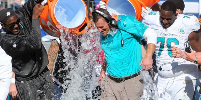 Oct 18, 2015; Nashville, TN, USA; Miami Dolphins interim head coach Dan Campbell is dumped with Gatorade after a win against the Tennessee Titans at Nissan Stadium. The Dolphins won 38-10. Mandatory Credit: Christopher Hanewinckel-USA TODAY Sports