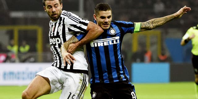 Juventus' defender from Italy Andrea Barzagli (L) fights for the ball Inter Milan's forward from Argentina Mauro Icardi during the Italian Serie A football match Inter Milan vs Juventus on October18, 2015 at the San Siro Stadium stadium in Milan. AFP PHOTO / OLIVIER MORIN (Photo credit should read OLIVIER MORIN/AFP/Getty Images)