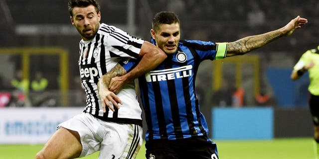 Juventus' defender from Italy Andrea Barzagli (L) fights for the ball Inter Milan's forward from Argentina Mauro Icardi during the Italian Serie A football match Inter Milan vs Juventus on October18, 2015 at the San Siro Stadium stadium in Milan. AFP PHOTO / OLIVIER MORIN (Photo credit should read OLIVIER MORIN/AFP/Getty Images)