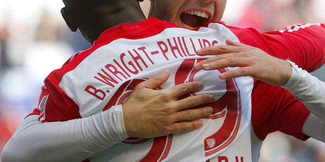 Oct 18, 2015; Harrison, NJ, USA; New York Red Bulls forward Mike Grella (13) hugs New York Red Bulls forward Bradley Wright-Phillips (99) after he scored a goal during first half against Philadelphia Union at Red Bull Arena. Mandatory Credit: Noah K. Murray-USA TODAY Sports