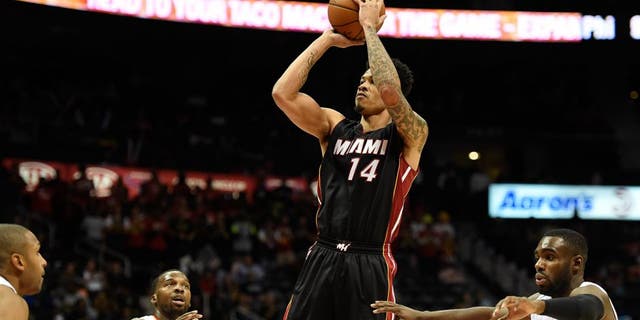 Oct 18, 2015; Atlanta, GA, USA; Miami Heat guard Gerald Green (14) shoots between three Atlanta Hawks players during the first half at Philips Arena. Mandatory Credit: Dale Zanine-USA TODAY Sports