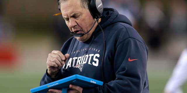 FILE - In this Dec. 6, 2015, file photo, New England Patriots head coach Bill Belichick studies a tablet device along the sideline during the first half of an NFL football game against the Philadelphia Eagles in Foxborough, Mass.