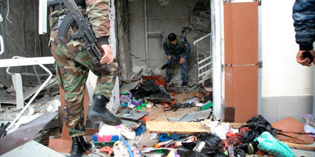Oct. 19: Special Force officers investigate the scene after a bomb blast in front of the Chechen parliament complex in Grozny.