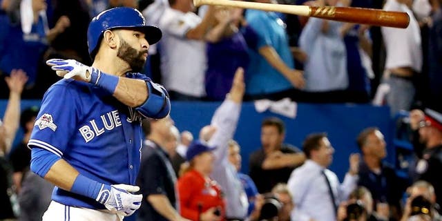 TORONTO, ON - OCTOBER 14: Jose Bautista #19 of the Toronto Blue Jays flips his bat up in the air after he hits a three-run home run in the seventh inning against the Texas Rangers in game five of the American League Division Series at Rogers Centre on October 14, 2015 in Toronto, Canada. (Photo by Tom Szczerbowski/Getty Images)