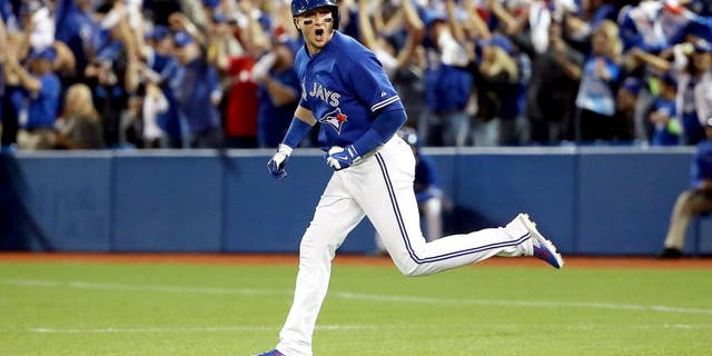 TORONTO, ON - OCTOBER 19: Troy Tulowitzki #2 of the Toronto Blue Jays runs the bases after hitting a three-run home run in the third inning against the Kansas City Royals during game three of the American League Championship Series at Rogers Centre on October 19, 2015 in Toronto, Canada. (Photo by Tom Szczerbowski/Getty Images)