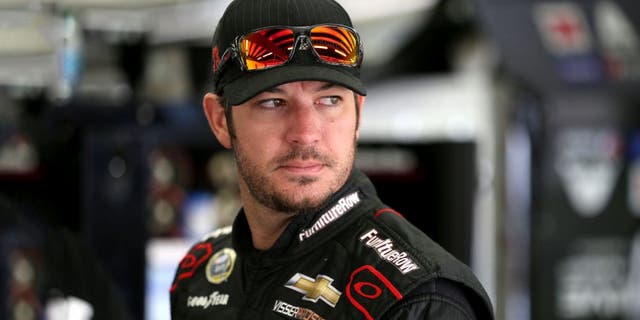 LOUDON, NH - SEPTEMBER 25: Martin Truex Jr., driver of the #78 Furniture Row/Visser Precision Chevrolet, stands in the garage area during practice for the NASCAR Sprint Cup Series Sylvania 300 at New Hampshire Motor Speedway on September 25, 2015 in Loudon, New Hampshire. (Photo by Todd Warshaw/NASCAR via Getty Images)