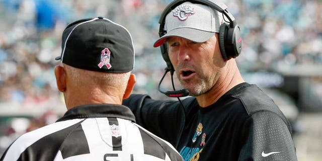 Oct 18, 2015; Jacksonville, FL, USA; side judge Tom Hill (97) listens as Jacksonville Jaguars head coach Gus Bradley complains about a call during the second half of a football game at EverBank Field. Houston won 31-20. Mandatory Credit: Reinhold Matay-USA TODAY Sports