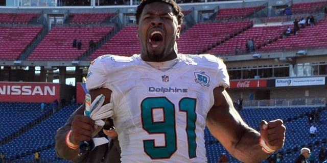 Oct 18, 2015; Nashville, TN, USA; Miami Dolphins defensive end Cameron Wake (91) celebrates as he leaves the field after his team defeated the Tennessee Titans during the second half at Nissan Stadium. Miami won 38-10. Mandatory Credit: Jim Brown-USA TODAY Sports