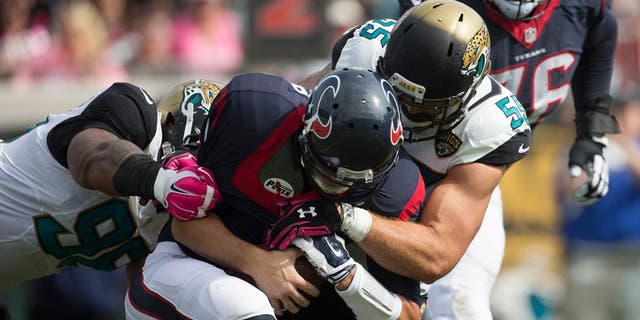 Oct 18, 2015; Jacksonville, FL, USA; Jacksonville Jaguars defensive tackle Roy Miller (97) and Jacksonville Jaguars outside linebacker Dan Skuta (55) sack Houston Texans quarterback Brian Hoyer (7) during the third quarter at EverBank Field. The Houston Texans won 31-20. Mandatory Credit: Logan Bowles-USA TODAY Sports