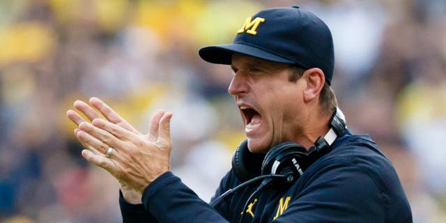Sep 10, 2016; Ann Arbor, MI, USA; Michigan Wolverines head coach Jim Harbaugh claps after a touchdown in the second half against the UCF Knights at Michigan Stadium. Michigan won 51-14. Mandatory Credit: Rick Osentoski-USA TODAY Sports
