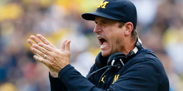 Sep 10, 2016; Ann Arbor, MI, USA; Michigan Wolverines head coach Jim Harbaugh claps after a touchdown in the second half against the UCF Knights at Michigan Stadium. Michigan won 51-14. Mandatory Credit: Rick Osentoski-USA TODAY Sports