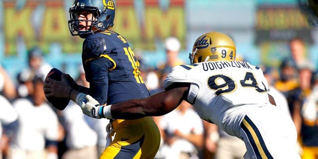 Oct 18, 2014; Berkeley, CA, USA; California Golden Bears quarterback Jared Goff (16) is unable to elude UCLA Bruins defensive lineman Owamagbe Odighizuwa (94) in the fourth quarter at Memorial Stadium. The Bruins defeated the Golden Bears 36-34. Mandatory Credit: Cary Edmondson-USA TODAY Sports
