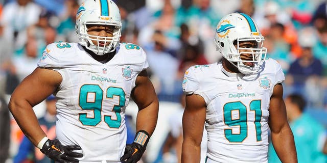 Oct 18, 2015; Nashville, TN, USA; Miami Dolphins defensive tackle Ndamukong Suh (93) and defensive end Cameron Wake (91) during the second half against the Tennessee Titans at Nissan Stadium. The Dolphins won 38-10. Mandatory Credit: Christopher Hanewinckel-USA TODAY Sports
