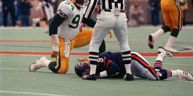 Green Bay Packer Charles Martin (94) checks on Bears quarterback Jim McMahon after slamming him to the ground Sunday, Nov. 23, 1986 at Soldier Field in Chicago. (Edward Wagner/Chicago Tribune/TNS)