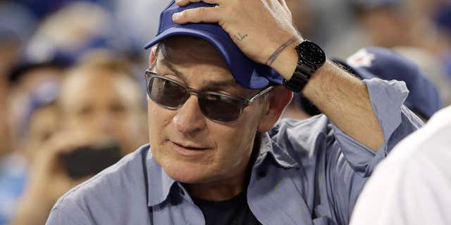 Actor Charlie Sheen reacts during the fifth inning of Game 4 of the National League baseball championship series between the Chicago Cubs and the Los Angeles Dodgers Wednesday, Oct. 19, 2016, in Los Angeles.
