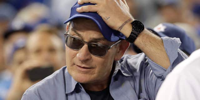 Actor Charlie Sheen reacts during the fifth inning of Game 4 of the National League baseball championship series between the Chicago Cubs and the Los Angeles Dodgers Wednesday, Oct. 19, 2016, in Los Angeles.