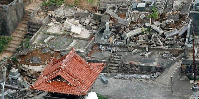 Oct. 21, 2016: This aerial photo shows fallen tomb stones scattered at a cemetery following an earthquake in Kurayoshi, Tottori prefecture.