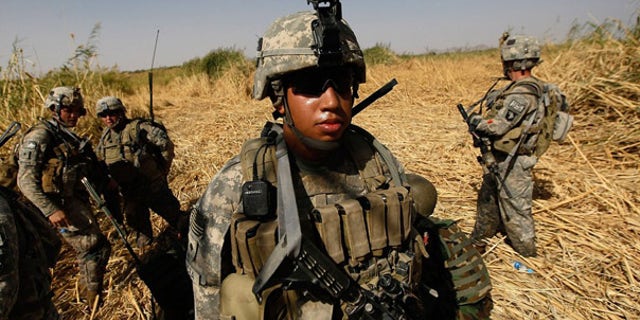 Oct. 15: U.S. Army soldiers march though tall grass and creeks to avoid buried bombs while on patrol near Kandahar.