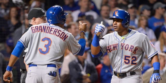 CHICAGO, IL - OCTOBER 21: Curtis Granderson #3 of the New York Mets and teammate Yoenis Cespedes #52 score on Lucas Duda's three-run home run in the top of the first inning of Game 4 of the NLCS against the Chicago Cubs at Wrigley Field on Wednesday, October 21, 2015 in Chicago, Illinois. (Photo by Ron Vesely/MLB Photos via Getty Images)
