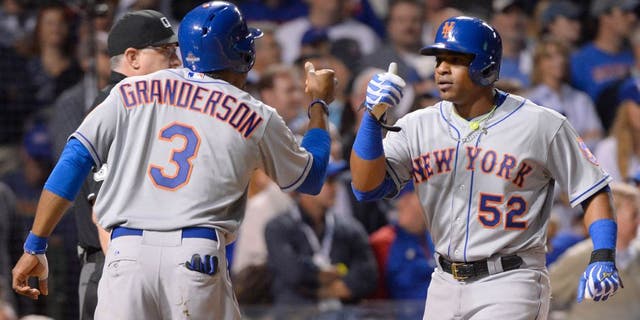 CHICAGO, IL - OCTOBER 21: Curtis Granderson #3 of the New York Mets and teammate Yoenis Cespedes #52 score on Lucas Duda's three-run home run in the top of the first inning of Game 4 of the NLCS against the Chicago Cubs at Wrigley Field on Wednesday, October 21, 2015 in Chicago, Illinois. (Photo by Ron Vesely/MLB Photos via Getty Images)