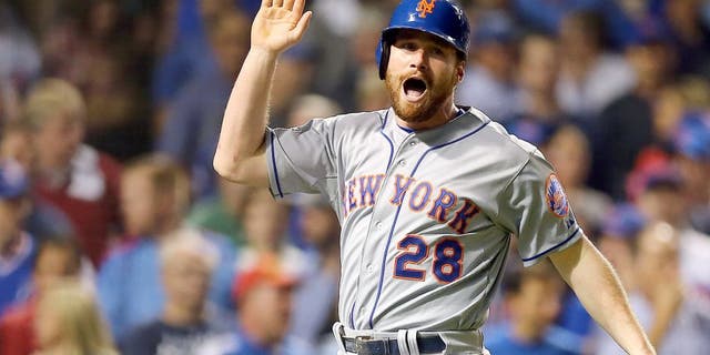 CHICAGO, IL - OCTOBER 21: Daniel Murphy #28 of the New York Mets celebrates after scoring off of a double hit by Lucas Duda #21 of the New York Mets in the second inning against Travis Wood #37 of the Chicago Cubs during game four of the 2015 MLB National League Championship Series at Wrigley Field on October 21, 2015 in Chicago, Illinois. (Photo by Elsa/Getty Images)