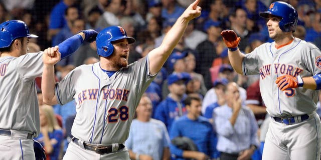 CHICAGO, IL - OCTOBER 21: Daniel Murphy #28 and David Wright #5 of the New York Mets celebrate after scoring on Lucas Duda's two-RBI double in the second inning of Game 4 of the NLCS against the Chicago Cubs at Wrigley Field on Wednesday, October 21, 2015 in Chicago, Illinois. (Photo by Ron Vesely/MLB Photos via Getty Images)