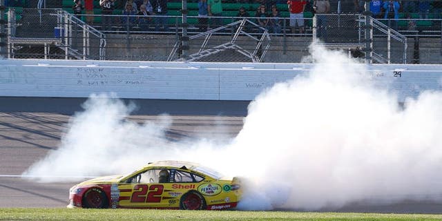 KANSAS CITY, KS - OCTOBER 18: Joey Logano, driver of the #22 Shell Pennzoil Ford, celebrates with a burnout after winning the NASCAR Sprint Cup Series Hollywood Casino 400 at Kansas Speedway on October 18, 2015 in Kansas City, Kansas. (Photo by Matt Sullivan/Getty Images)